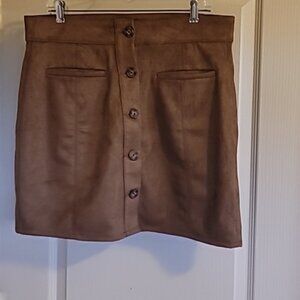 Brown skir suede-like feel. 93% polyester 7% spandex